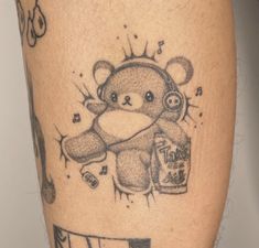 a tattoo with a teddy bear holding a beer