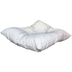 a white and blue striped pillow sitting on top of a bed