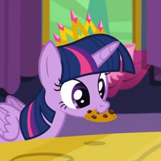 the pony is eating some cookies on the table in front of her friend's bed