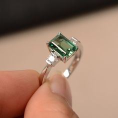 This is a gorgeous handmade creation. Its beauty is its simplicity & Elegance. The 6*8mm emerald cut lab green sapphire is crafted in solid sterling silver and with rhodium plated. All item is sent in a beautiful gift box You can realize more lovely stuff clicking the link https://www.etsy.com/shop/knightjewelry?refshopsection_shophome_leftnav Please leave the correct address and you phone number for delivering successfully. Emerald Cut Moissanite Promise Ring, Green Emerald Cut Sapphire Ring, Green Radiant Cut Ring With Accent Stones, Green Radiant Cut Rings With Accent Stones, Radiant Cut Green Rings With Accent Stones, Emerald Cut Sapphire Ring For Proposal, Green Emerald-cut Sapphire Wedding Ring, Green Sapphire Ring With Prong Setting, Emerald Cut, Green Emerald Cut Sapphire Ring With Prong Setting