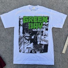 Up For Sale Is A - Green Day Shirt Band Tee Size: Mens Small Measurements:Please See Photos Above For All Measurements Good Used Condition Nice Logo I Will Ship This Item Out Via Usps 2-3 Day Mail With A Tracking Number For Confirmationi Ship Items Out Every Day So Expect A Quick Delivery!Please Feel Free To Ask Any Questions You May Havei Answer Most Questions Instantly!All Clothing Has Been Cleaned Per Ebay Policies D111 Green Punk Style T-shirt For Streetwear, Casual Shirt With Screen Print For Alternative Fashion, Cotton Graphic Print Shirt For Alternative Fashion, Cotton Shirt With Graphic Print For Alternative Fashion, Alternative Style Summer Concert Shirt, White Grunge Shirt For Concert, Alternative Style Fan Merchandise Shirt With Screen Print, Summer Punk Shirt For Alternative Fashion, Punk Style Streetwear Shirt For Summer