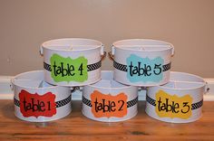 four buckets with labels on them that say table 4, table 2 and table 3