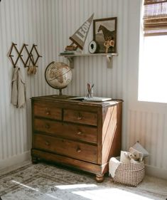 a dresser in a room with striped walls