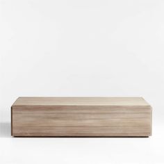 an empty wooden box sitting on top of a white surface with no one around it