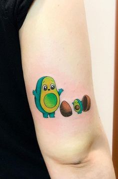 a small tattoo on the arm of a woman with an avocado and chick