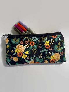 "This listing has six options to choose from. All pouches are made with a high quality Rifle Paper fabric print on the outside.  Interfaced for stability. Secured with a quality zipper. The inside is lined with 💯 cotton fabric. Dimensions: 9\" in length x 5\" in length. Perfect as a pencil case, cosmetics case, cash holder or accessory pouch.  Care: wash in a gentle cycle using cold water and air dry for best results.  Thank you for visiting Gratitude Oasis." Rectangular Zipper Pouch Stationery, Artistic Zipper Pencil Case As Gift, Rectangular Organizer With Pen Slots For Gift, Rectangular Organizers With Pen Slots As Gift, Portable Pencil Organizer As Gift, Rectangular Organizer With Pen Slots As Gift, Rectangular Pen Holders For Personal Use, Personal Zipper Pouch Pencil Organizer, Green Zipper Pouch Stationery Gift