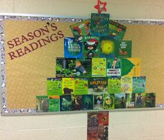 there is a christmas tree made out of books on the bulletin board in this classroom