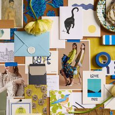 a collage of photos, pictures and other items on a wall with yellow flowers