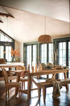 a dining room table with chairs and a bench