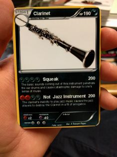 a person holding a card with a musical instrument on it