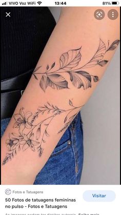 a woman's arm with flowers and leaves tattooed on the left side of her arm