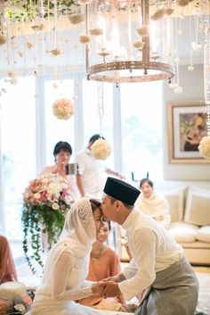 a bride and groom are getting ready to cut their wedding cake at the reception table