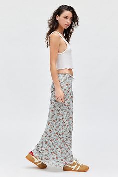 Vintage-inspired UO skirt in a body-skimming maxi silhouette. Designed in a soft & stretchy floral printed mesh featuring a low-rise waistline that sits at the hips topped with a satin bow detail & finished with a ruffled lettuce-edge hem. Exclusively at Urban Outfitters. Features UO floral mesh low rise column maxi skirt Floral slip maxi skirt Soft & stretchy floral print mesh Low-rise elasticated waistline Satin bow detail at center front Ruffled lettuce-edge trimmed hem Slim, body-skimming si Singapore Outfit, Cute Maxi Skirts, Skirt Floral, 2024 Christmas, Floral Maxi Skirt, Blue Fits, Suede Skirt, Satin Bow, Bow Detail