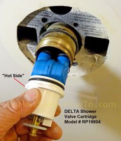 a close up of a person adjusting the valve on a water heater