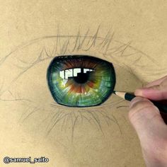 someone is drawing an eye with colored pencils