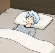 a person laying in bed with an unmade pillow