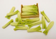 several pieces of celery sitting on top of a white table next to each other