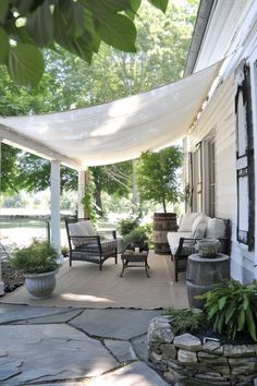 an outdoor covered patio with chairs and tables