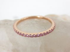 This feminine light pink sapphires eternity band is the perfect complement to any engagement ring or as stackable bands. *Based on ring size 6.5 *Metal: 18K Rose Gold *Stones: Genuine Sapphires *Color: Light Pink *Stone Count: 44 PCS *Weight: 0.43cts T.W *Band Width: 1.5mm ( +/- 0.1mm in variation) ---------------------------------------- Carat weight & stone count varies depending on the ring size. ---------------------------------------- Beautiful Ring Box Included ------------------------ Fine Jewelry Pink Round Cut Eternity Band, Pink Round Cut Stackable Eternity Band, Pink Half Eternity Round Band, Fine Jewelry Pink Sapphire Eternity Band With Prong Setting, Fine Jewelry Pink Eternity Band With Gemstone, Pink Gemstone Eternity Band Fine Jewelry, Pink Stackable Eternity Band As Gift, Dainty Rose Gold Half Eternity Band, Pink Half Eternity Stackable Rings In Fine Jewelry