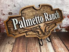 a wooden sign that says palmetto ranch on the side of a wood flooring wall