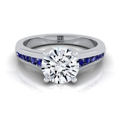 a diamond and blue sapphire engagement ring with channel set diamonds on the side, in white gold