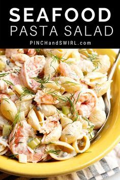 a yellow bowl filled with pasta salad on top of a table