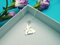 Sterling silver two layer mom and baby bunny charm represents a celebration of life, love, and protection. Mama and baby bunnies often snuggle together in their warm, safe haven. To keep dry and warm, rabbits often live in underground burrows where mama rabbits can better protect their little ones. Buy the charm or get this with our Italian Rolo Chain. » Sterling Silver Charm (21 x 15 x 1 mm including the rings) » Sterling Silver Italian Rolo, marked 925 » Your jewelry will come packaged for gif Easter Bunny Design Jewelry Gift, Personalized Jewelry For Easter Gifts, Bunny Jewelry, Rabbit Necklace, Rabbit Jewelry, Easter Bunny Gifts, Bunny Mom, Mommy Jewelry, Bunny Necklace