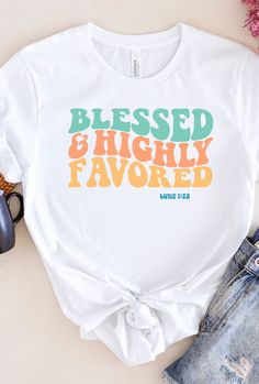 "My Description Our \"Blessed & highly favored\" shirt makes for a great gift. The comfortable fit and cool design of this shirt means that it feels just as good to wear as it is to look at. If you've been looking for an inspirational t-shirt for yourself, or your friend or family member, you should get this tee today. Bella + Canvas Brand Shirt ▶Unisex Adult Sizing ▶See Our Size Chart For Proper Sizing ▶Rolled sleeves are for styling purposes only ▶Props used in photos are not included with the White Graphic Tee With Lettering, Crew Neck T-shirt With Lettering For Gift, Inspirational White T-shirt For Gift, Inspirational White T-shirt As Gift, Inspirational White Shirt With Graphic Print, White Graphic Tee Shirt With Lettering, Inspirational Letter Print White T-shirt, Inspirational White T-shirt With Letter Print, Inspirational Graphic Print T-shirt As Gift