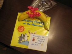 a banana wrapped in plastic sitting on top of a table next to a card and envelope