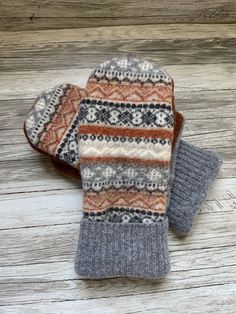 Upcycled wool sweater mittens. These cozy mittens are perfect for cold winter days. This pair is made from four different sweaters I washed in hot water to felt.  The inside is lined with cozy warm fleece.  This pair would fit most women's  hands. Measurement are 9.5 inches top to bottom and 4.5 inches wide.  Each pair is a one of a kind creation  Hand wash and lay flat to dry Looking for a certain color?  Send me a note and I will create a pair for you! Mittens were made from a pattern from  ww Sweater Mittens, Recycled Sweaters, Wool Mittens, Winter Days, Winter Day, Mitten Gloves, Wool Sweater, Cold Winter, In Hot