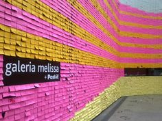 there is a wall made out of pink, yellow and orange strips with the word galaeria melissa on it