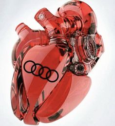 a red heart shaped glass sculpture with the word audi printed on it