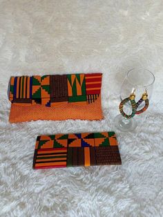 **African çlutch bags,African print bag,African leather purses, women purses.***They are made out of kente  and jute material***They are fabulous way to bring taste to any outfit.**Comes with a matching wallet.and earrings.. ***Perfect christmas gift for her***For wholesale kindly message us.Ship via dhl express.Thank you for stopping by. Trendy Handmade Clutch As Gift, Orange Clutch Bag For Gift, Orange Clutch Bag As A Gift, Envelope Bag For Gifts, Orange Pouch Clutch For Gift, Orange Pouch Clutch As Gift, Rectangular Orange Clutch For Gift, Rectangular Orange Clutch As Gift, African Christmas