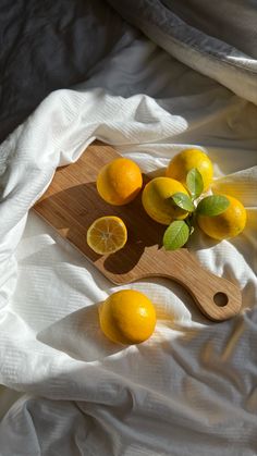 some lemons are sitting on a cutting board