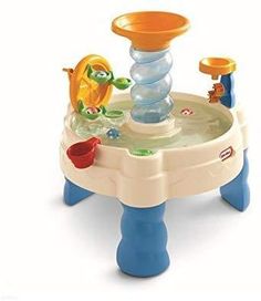 an infant's toy water table with toys on the top and around it,