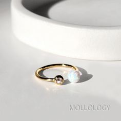 This delicate opal ring is handcrafted 14K shiny gold finish, with lustrous opal and bezel CZ that gently wraps around your finger.  It's perfect for dressy look or everyday wear for a minimalist style!  Product Details: * 14k Gold Finish, THICK layer of plating for long lasting! * Opal stone: 6 mm dia. | Cubic Zirconia: 3mm dia. * High Quality Lab created Fire Opals + Cubic Zirconia * Size: open/adjustable * Sold individually not as a pair.  Also available in store: ⚙︎ Dainty Opal Studs  https: Gold Opal Ring, Opal Stacking Ring, Blue Opal Earrings, White Opal Ring, Zierlicher Ring, Ring Opal, Opal Ring Gold, Opal Studs, Ring Minimalist