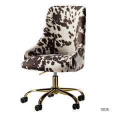 an office chair with a cow print upholstered on it's back and wheels