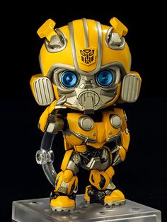 a yellow and silver robot with blue eyes