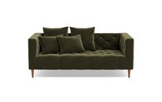 a green couch with four pillows on it