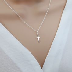 Small cross necklace, sterling silver cross necklace women, cross pendant, religious catholic jewelry, tiny cross necklace Our small cross necklace is super dainty & minimalistic - perfect for layering with other necklaces. Would make the perfect meaningful gift for yourself or someone special.  Explore our gorgeous collection of dainty and personalised necklaces and bracelets. Lovingly handcrafted for you, our beautiful, collectable pieces combine minimalism and personalisation.  https://www.et Small Silver Cross Necklace, Silver Cross Necklace Aesthetic, Silver Cross Necklace Woman, Small Cross Necklace, Cross Pendant Men, Tiny Cross Necklace, March Birthstone Necklace, Cross Necklace Women, Silver Cross Necklace