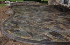 an outdoor patio with stone pavers and brick walls