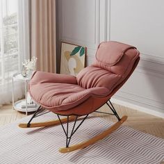 a living room with a rocking chair and rug