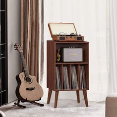 a record player and guitar in a living room