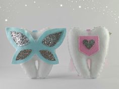 two toothbrushes decorated with glitter and hearts