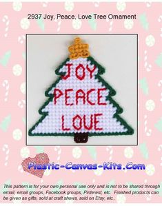 a cross stitch christmas tree ornament with the words joy peace love