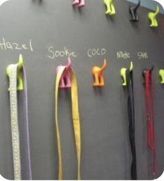 a chalkboard with several different colored ribbons hanging on it