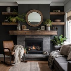 a living room filled with furniture and a fire place in front of a mirror on the wall