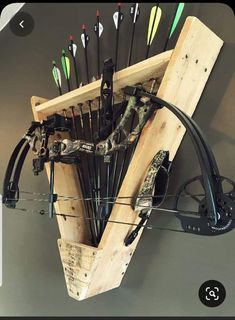 the bow rack is made out of wood and has arrows attached to it, as well as an arrow