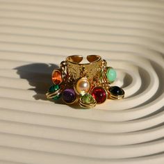 💎 Make a statement with our Gold Chunky Boho Ring! This thick band ring, with its multicolor gemstones and irregular design, is the perfect blend of baroque style and boho chic. An adjustable band ensures a comfy fit, making it an ideal gift for lovers of maximalist, boho and Y2K rings. Elevate your Fall look with this trendy, aesthetic ring! 🌟✨  #GoldChunkyRing #BaroqueRing #ChunkyBohoRing #MulticolorRing Refunds/Returns: You have 14 days after receiving the product to get all of your money b Multicolor Metal Rings For Gifts, Multicolor Open Crystal Ring, Handmade Multicolor Open Ring Jewelry, Multicolor Metal Bohemian Rings, Bohemian Multicolor Metal Rings, Open Ring With Jewels, Handmade Multicolor Metal Rings, Unique Adjustable Multi-stone Crystal Ring, Adjustable Multi-stone Crystal Ring In Unique Style