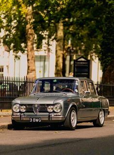 an old car is parked on the side of the road